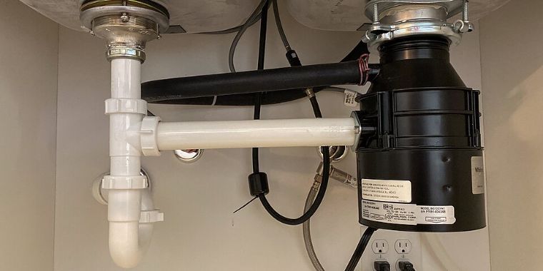 Garbage disposal installed under a kitchen sink