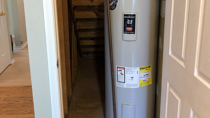 Tank water heater in a narrow closet inside a house